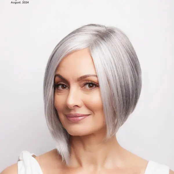 Woman with short silver hair smiling.