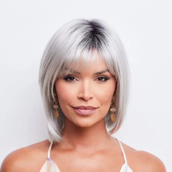 Woman with short, silver hair and earrings.
