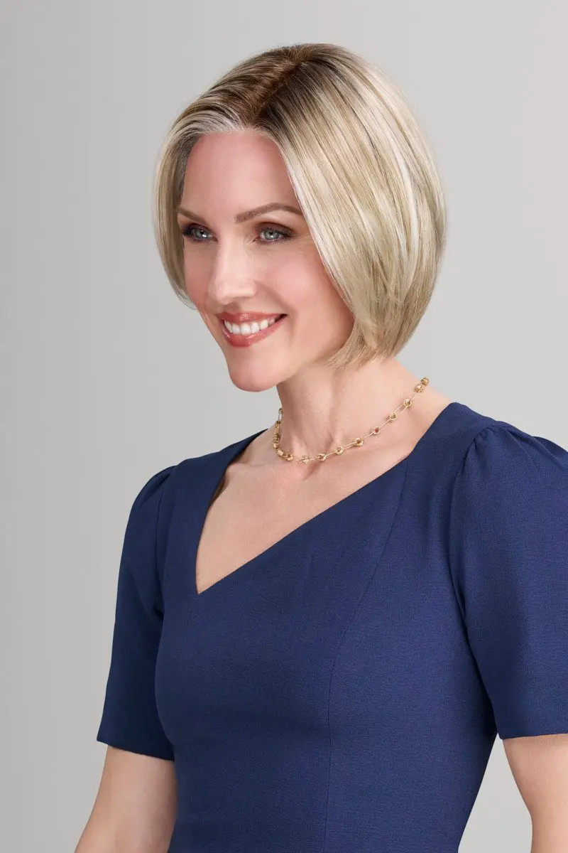 Smiling woman with short blonde hair.