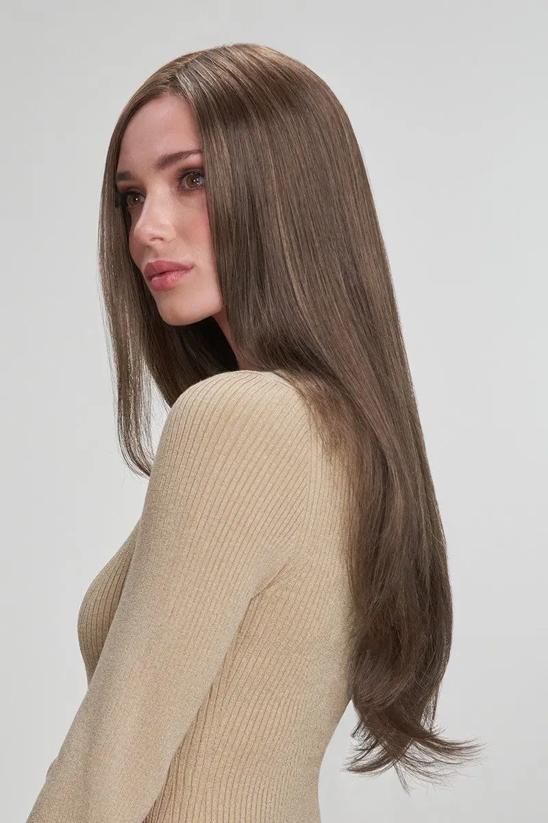 Woman with long brown hair, beige top.