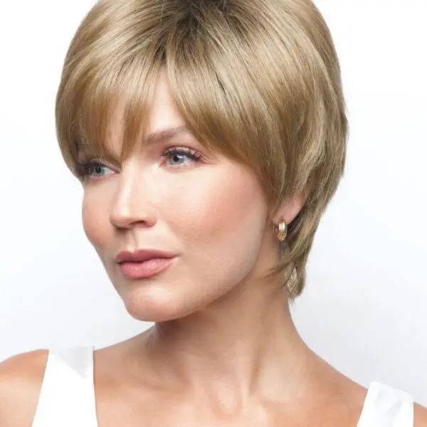 Woman with short blonde hairstyle, white top.