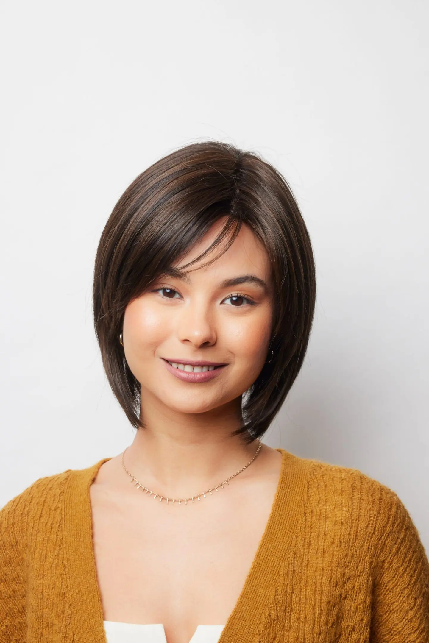 Smiling woman with short brown hair.
