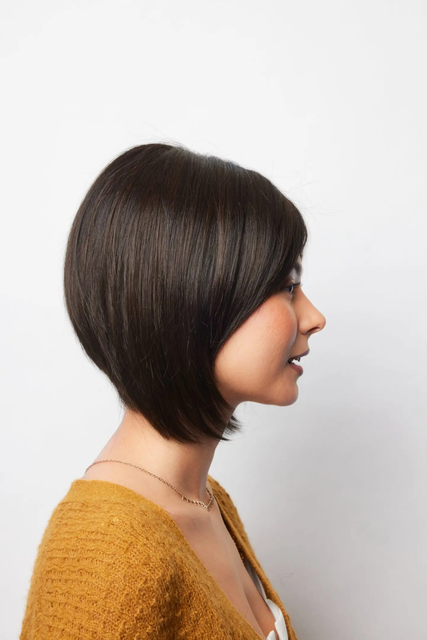 Woman with short brown bob haircut.