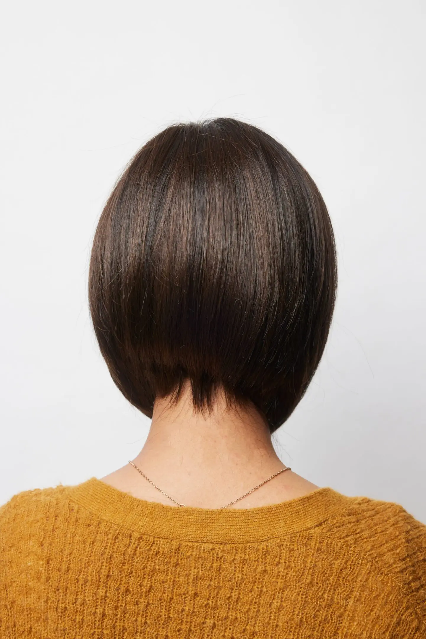 Back view of person with short hair.