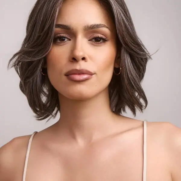 Woman with short hair and neutral expression.
