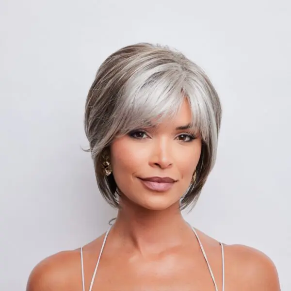 Woman with short, gray-highlighted hairstyle.
