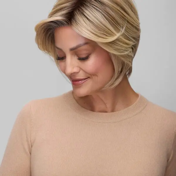 Smiling woman with short blonde hair.