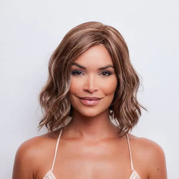 Woman with short, wavy brown hair smiling.