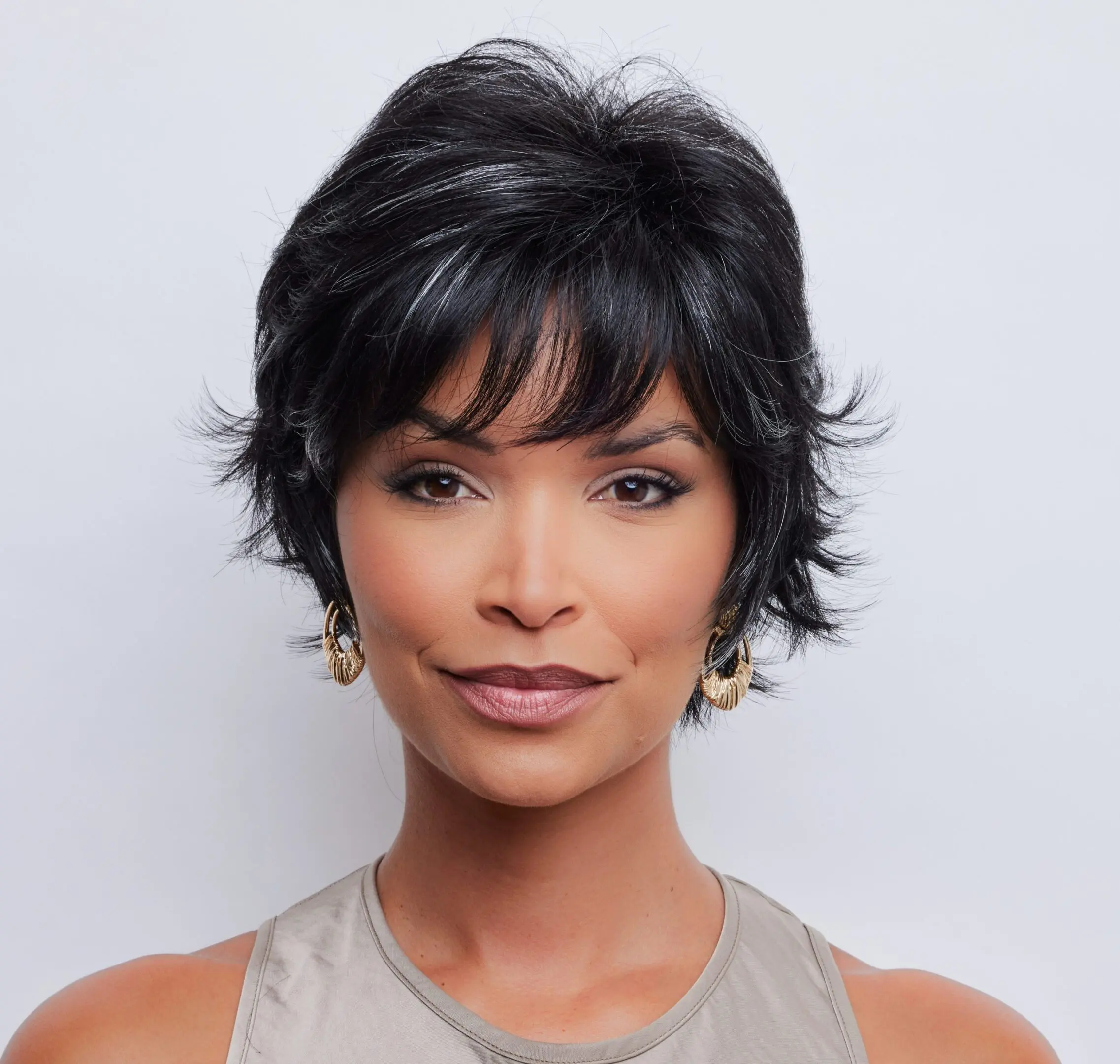 Woman with short black hair and earrings.