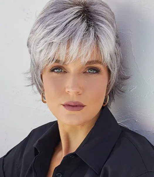 Woman with short silver hair, black shirt.