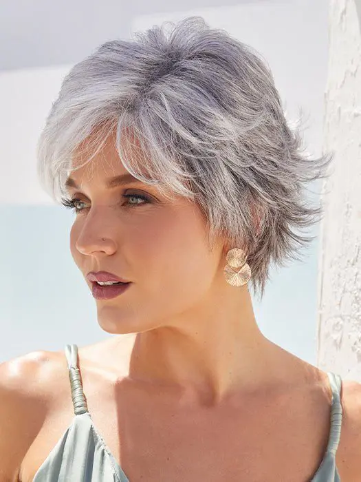 Woman with short silver hair and earrings.