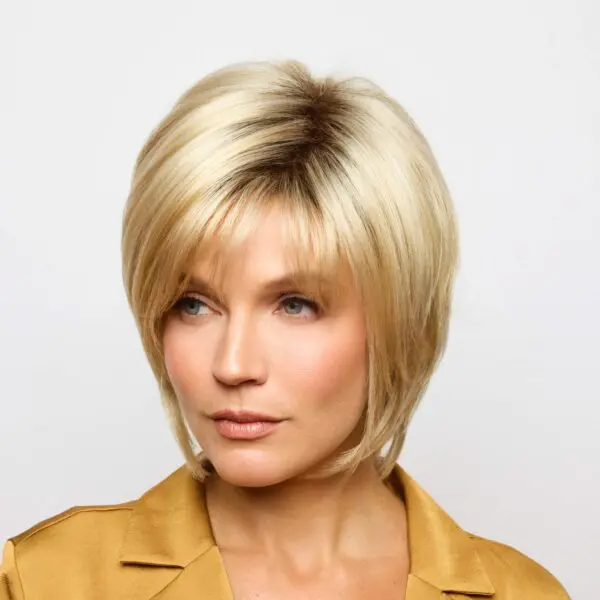 Woman with short blonde hairstyle, wearing jacket.