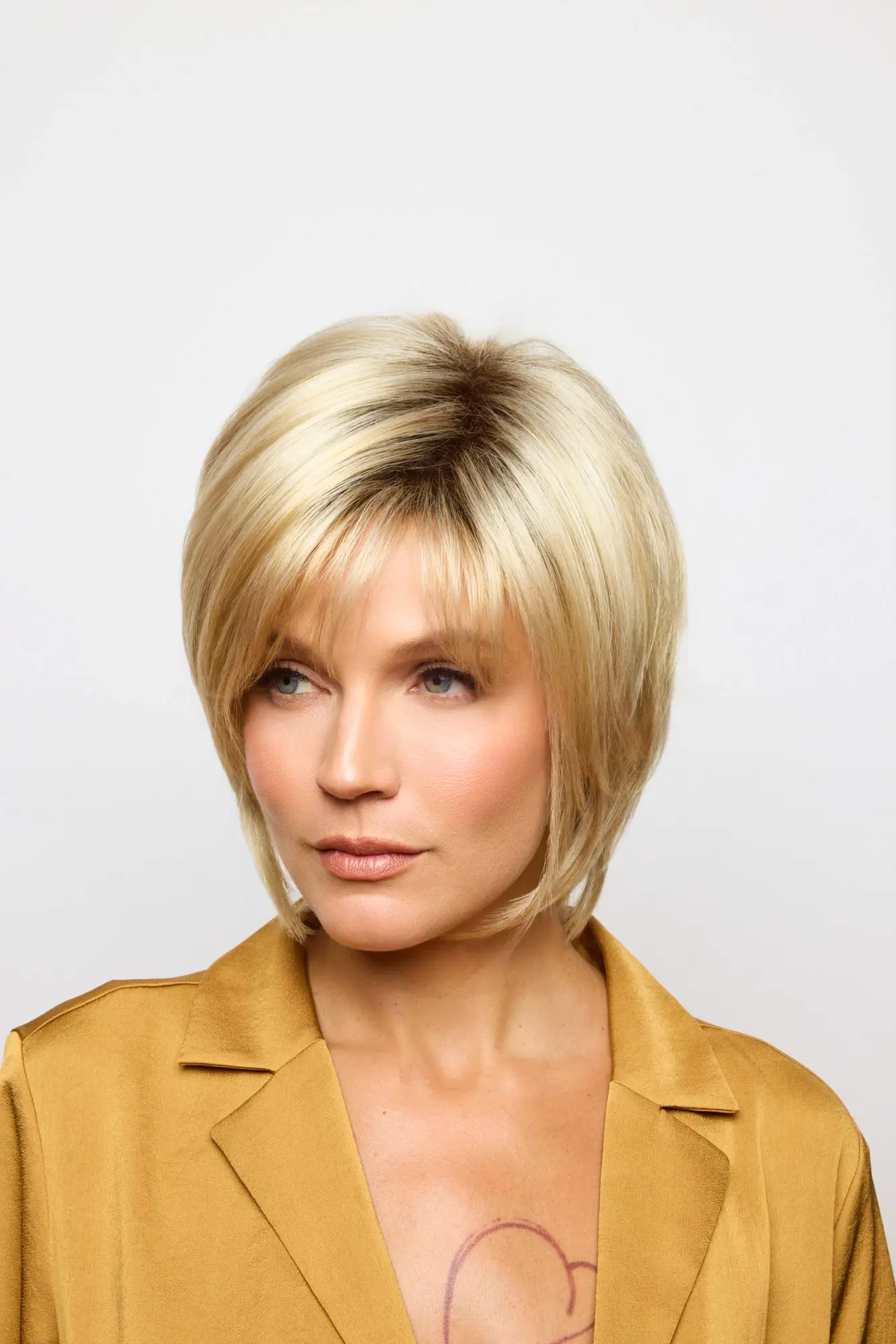 Woman with short blonde hairstyle, wearing jacket.