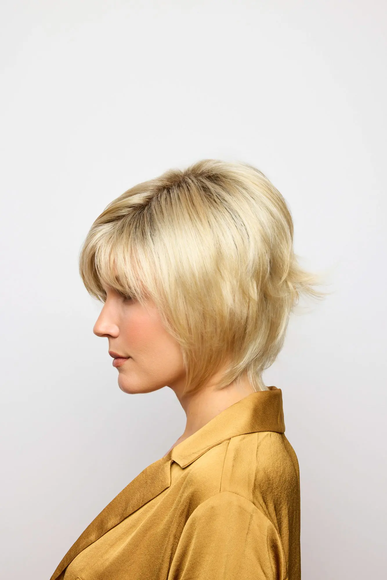 Woman with short blonde hair, side view.
