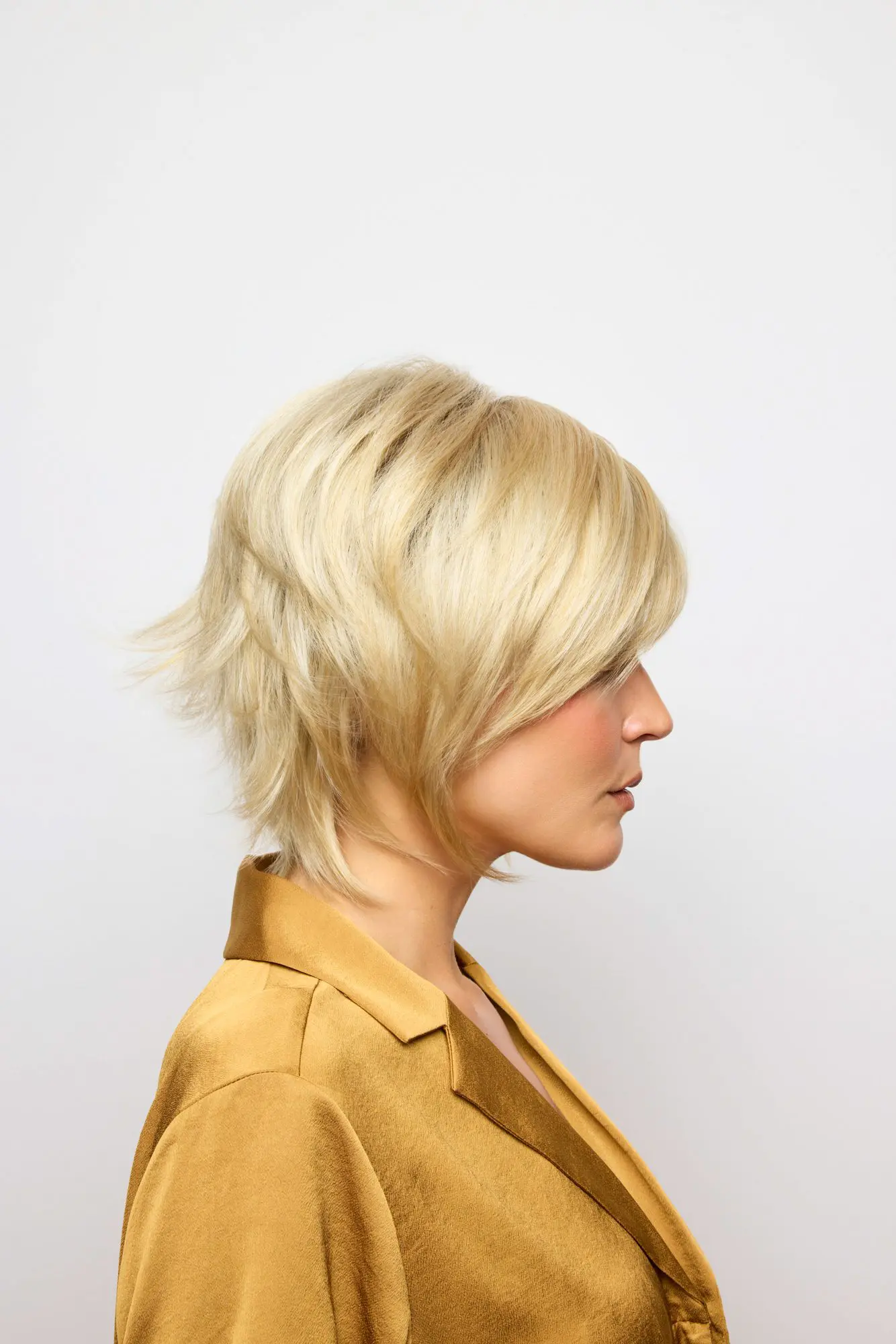 Woman with short blonde hair, side profile.