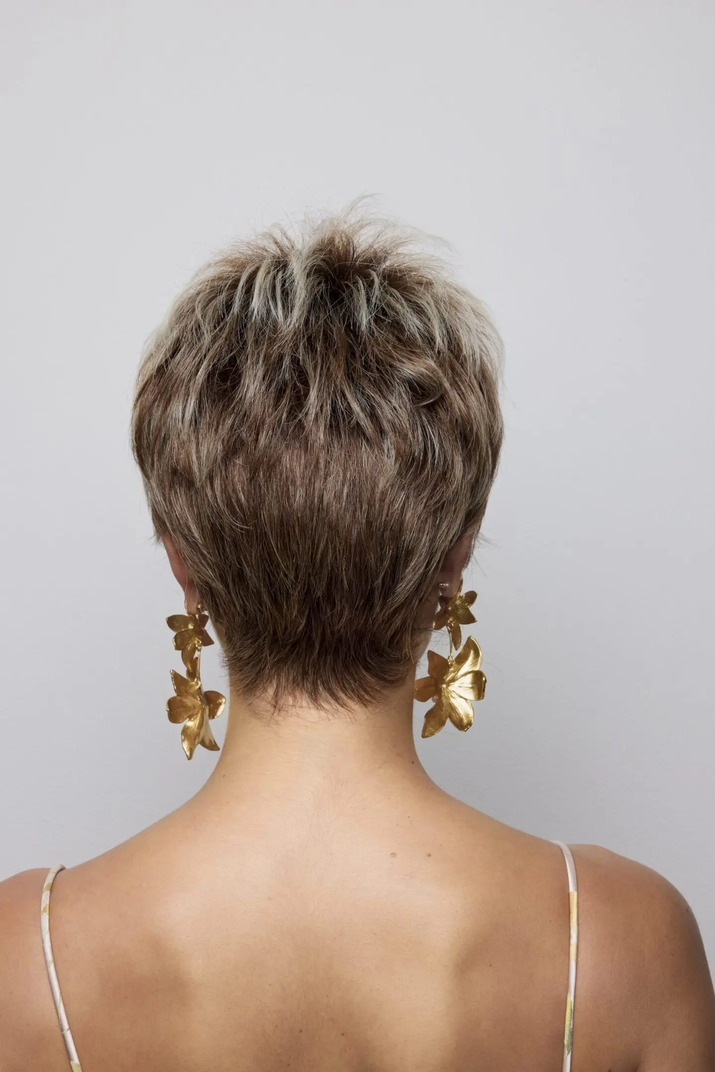 Woman with short hair and large earrings.