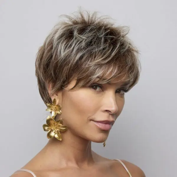 Woman with short hair and gold earrings.