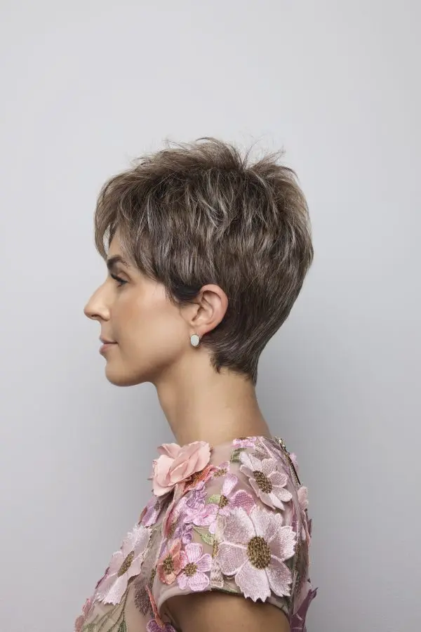 Woman with short hair, floral dress.