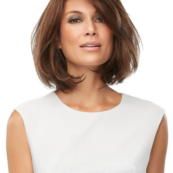 Woman with brown bob hairstyle, white top.